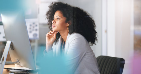 Female IT working on a desktop computer. Happy Information Technology operation professional or expert doing software management for work efficiency in tech organization or business companyの写真素材