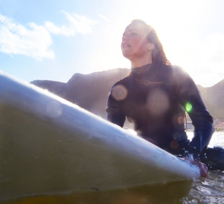 This is where I feel alive...a young woman on her surfboard in the sea.