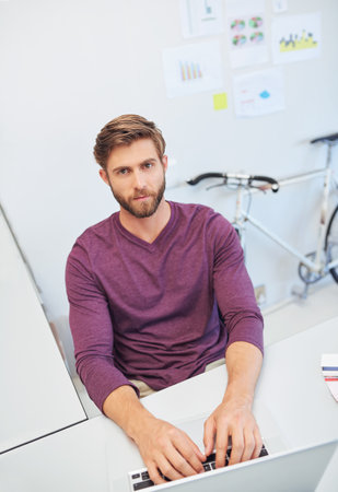 Putting in the work. Cropped portrait of a young architect working on his latop.の写真素材