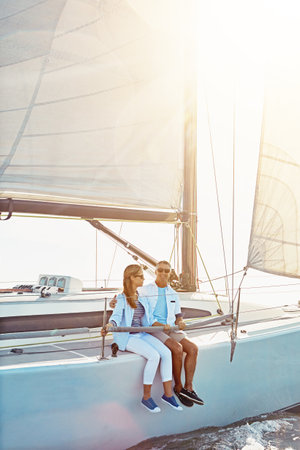 Take advantage of moments like these. a couple enjoying a boat cruise out on the ocean.の写真素材