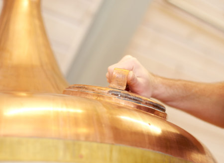 Brewery, copper tun and tank for beer, alcohol or brewing process with hatch. Man, hand and alcohol...