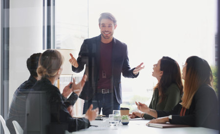I think youre all going to love my new plan. a young businessman giving a presentation to his colleagues in an office.の写真素材
