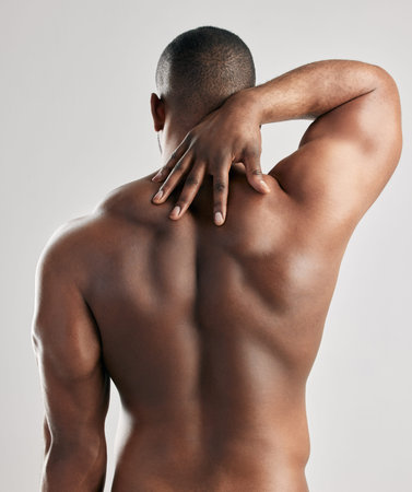 There is no strength without struggle. Studio shot of a unrecognizable male flexing his back muscles...