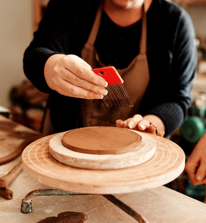 All you need is the right tools. an unrecognizable artisan working in a pottery workshop.の写真素材