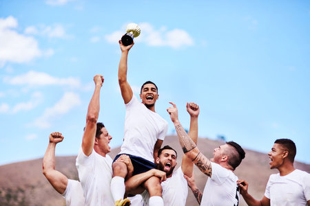 The more challenging the game, the greater the victory. a group of young rugby players celebrating after winning a game.の写真素材