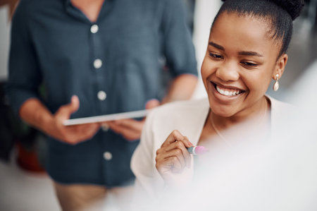 Her ideas are great. an attractive young businesswoman using a visual aid to brainstorm with her colleagues in the office.の写真素材