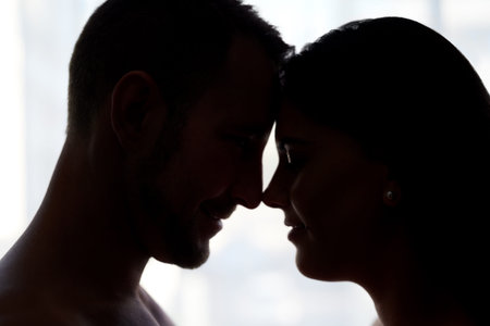Love is all they need. an affectionate young couple about to kiss in their bedroom.