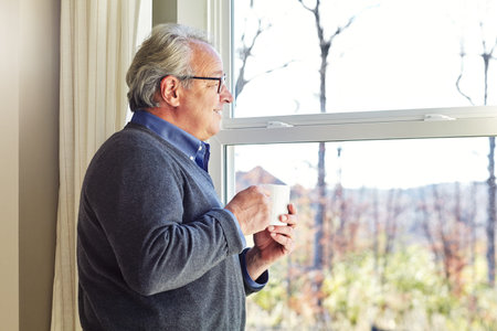 Looks like a beautiful day. a senior man relaxing at home.