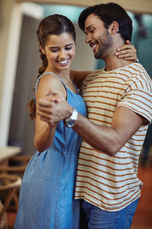 This kitchen is for dancing. an affectionate young couple dancing in their kitchen at home.