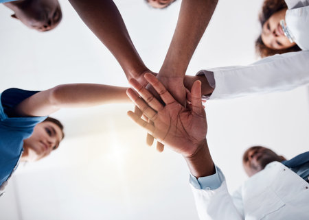 I couldnt have asked for better team to work with. Low angle shot of a group of doctors forming a...