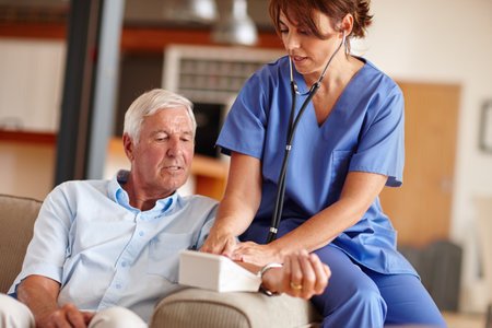 Lets check your blood pressure. a doctor checking a senior patients blood pressure.の写真素材