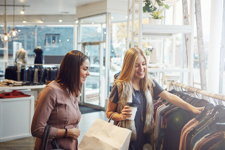 I like everything I see. two girlfriends out on a shopping spree together.の写真素材
