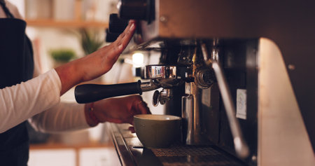 Coffee machine, barista hands and woman in cafe, prepare latte or espresso drink with service and premium blend caffeine. Hot beverage, person working in restaurant and cup with brewing processの写真素材