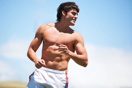 Making all the girls drool. a shirtless young athlete outdoors.の写真素材