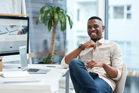 You have to work hard if you want rewards. Portrait of a young businessman working in an office.