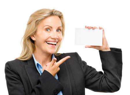 Youll always be remembered by your card. a mature businesswoman holding a blank business card against a studio background.の写真素材