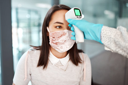 Taking the necessary protective measures in the workplace. a young businesswoman getting her...