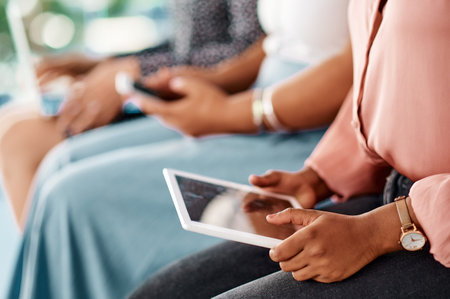 Everything you need can be in one small device. a group of unrecognizable businesswomen using...