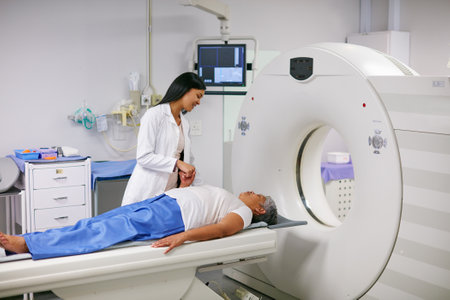 Doctor, mri and woman holding hands of patient in hospital before scanning in machine. Ct scan, comfort and medical professional with senior female person in radiology test for healthcare in clinic.の写真素材