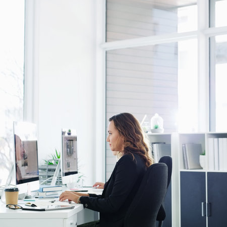 Do what you need to do to get it done. a confident young businesswoman using a computer at her desk...