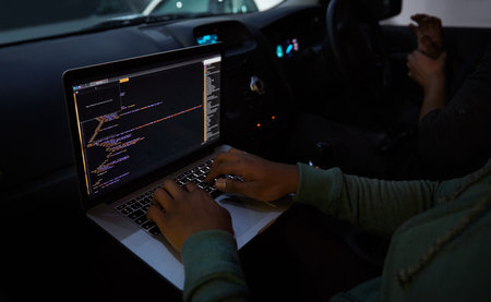 Hacker, code and laptop with person in car for ransomware, cyber security and phishing. Coding, technology and crime with hands of programmer typing for fraud, network system and data scam at nightの写真素材