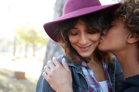 Love is love. a young couple spending the day outdoors on a sunny day.の写真素材