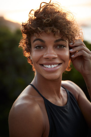 Hey there pretty brown eyes. Portrait of a beautiful young woman spending the day outdoors on a sunny day.の写真素材