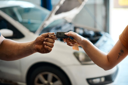 Your car is as good as new. a woman receiving her car keys.の写真素材