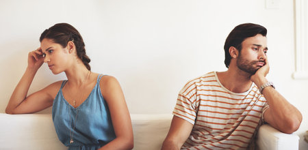 Im tired of arguing. a young couple having an argument while sitting on their couch at home.の写真素材