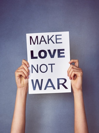 Make your voice heard. an unidentifiable young woman holding up a poster with a message on it in...
