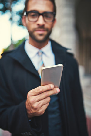 Never get lost with a navigation app. a stylish man using his phone in the city.の写真素材