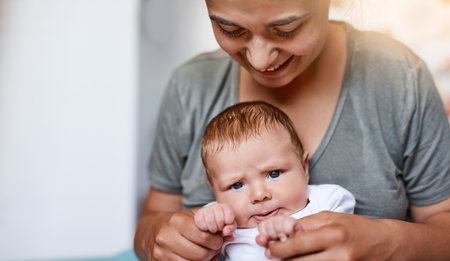 Babies bring so much love and joy into your life. a young woman bonding with her baby boy at home.の写真素材