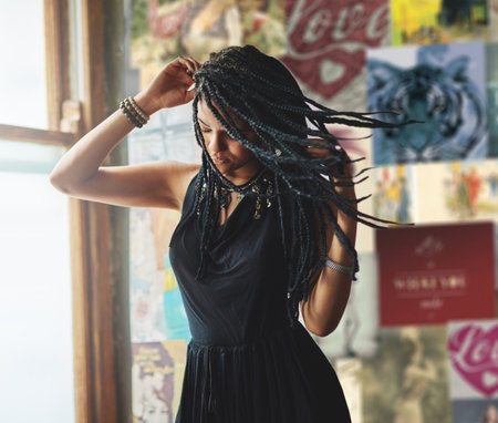 Express yourself. an attractive young woman standing by the window.の写真素材