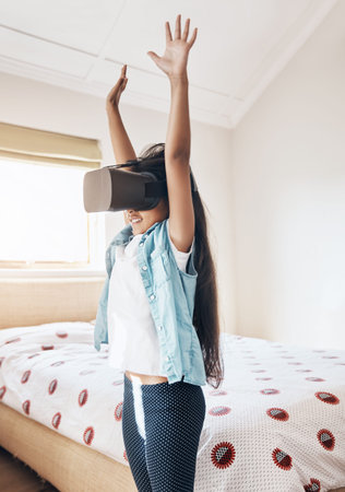 Fun entertainment for this generation. a young girl using a virtual reality headset at home.