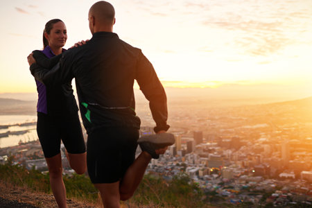 Its great having an exercise buddy. a young couple stretching before a run.の写真素材