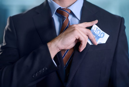 Dealing in the illegal. Cropped image of a businessman pocketing some cash.