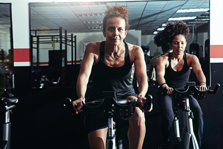 Set your goal, and always move forward. two women working out in a gym.の写真素材