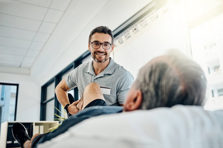 Hows that hamstring feeling now. a friendly physiotherapist treating his mature patient in a...