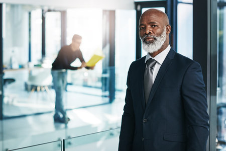 Remember you can survive, emerge and succeed. Portrait of a mature businessman standing in a modern office.の写真素材