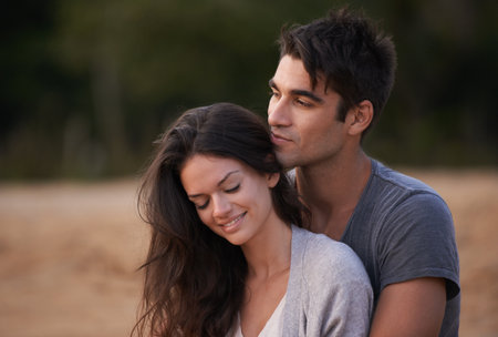 A special bond. an affectionate young couple at the beach.の写真素材