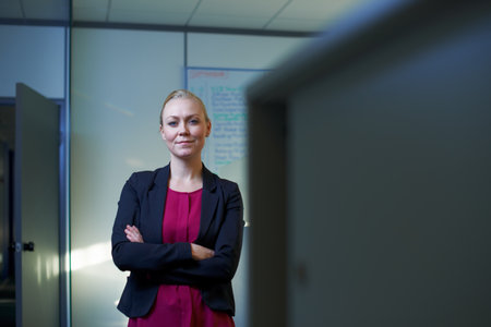 This office is my domain. Portrait of an attractive businesswoman standing with her arms crossed in the office.の写真素材
