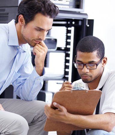 Teamwork, IT and men with clipboard in server room for maintenance, inspection and fixing....