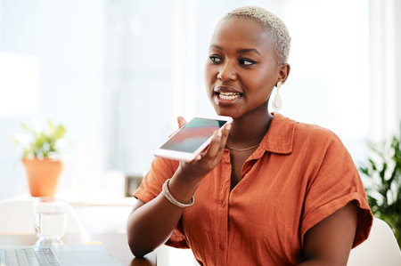 Saving some voice notes to listen to later. a young businesswoman talking on a cellphone in an...