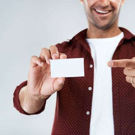 You can contact me using this. Studio shot of an unrecognizable man holding and displaying a...