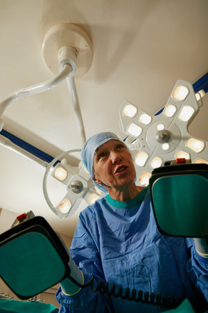 Clear. a surgeon using a defibrillator during surgery.