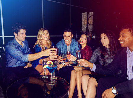 May the fun never end. a group of friends toasting with drinks at a party.の写真素材