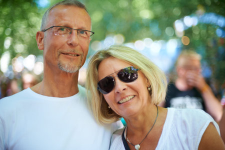 Enjoying the festival together. Portrait of an affectionate mature couple at an outdoor festival.の写真素材