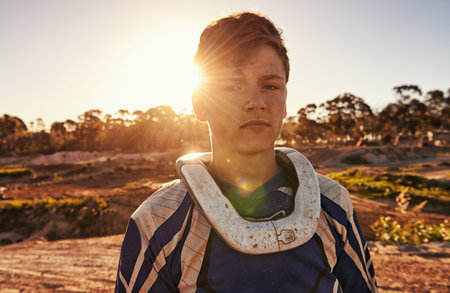 Passion comes with a bit of dirt. Portrait of a dirtbike race standing in his race gear.