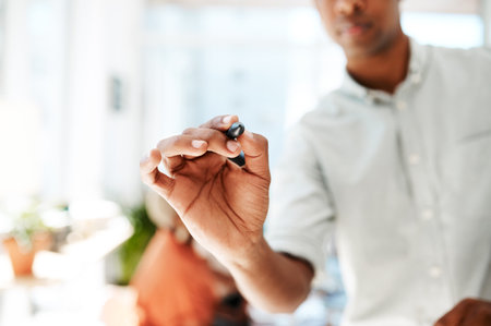 Write your goals into existence. Closeup shot of an unrecognisable businessman holding a marker in an office.の写真素材