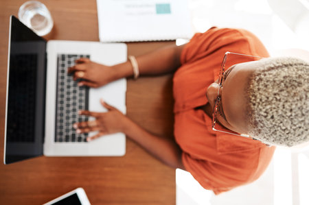 Success doesnt lie in results, but in your efforts. High angle shot of a young businesswoman working on a laptop in an office.の写真素材